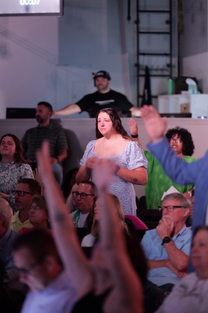 Congregation with hands raised in worship