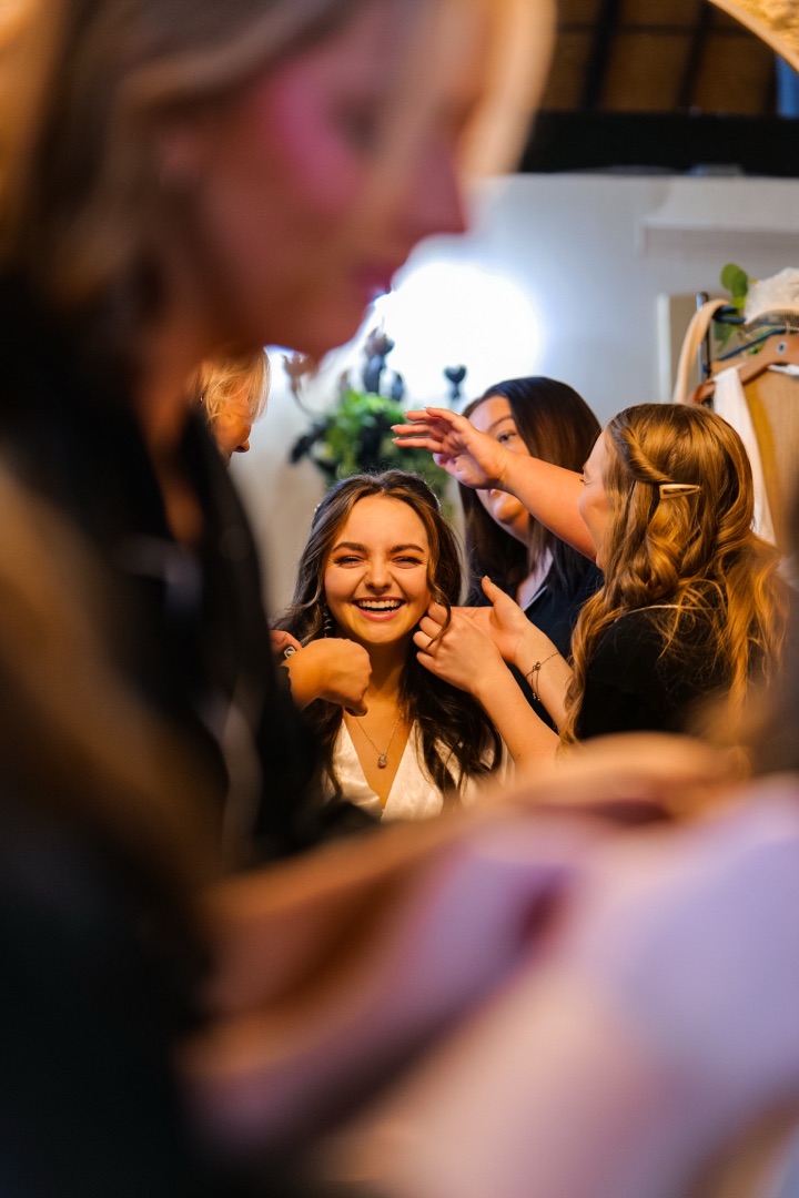 Bride laughing while getting ready